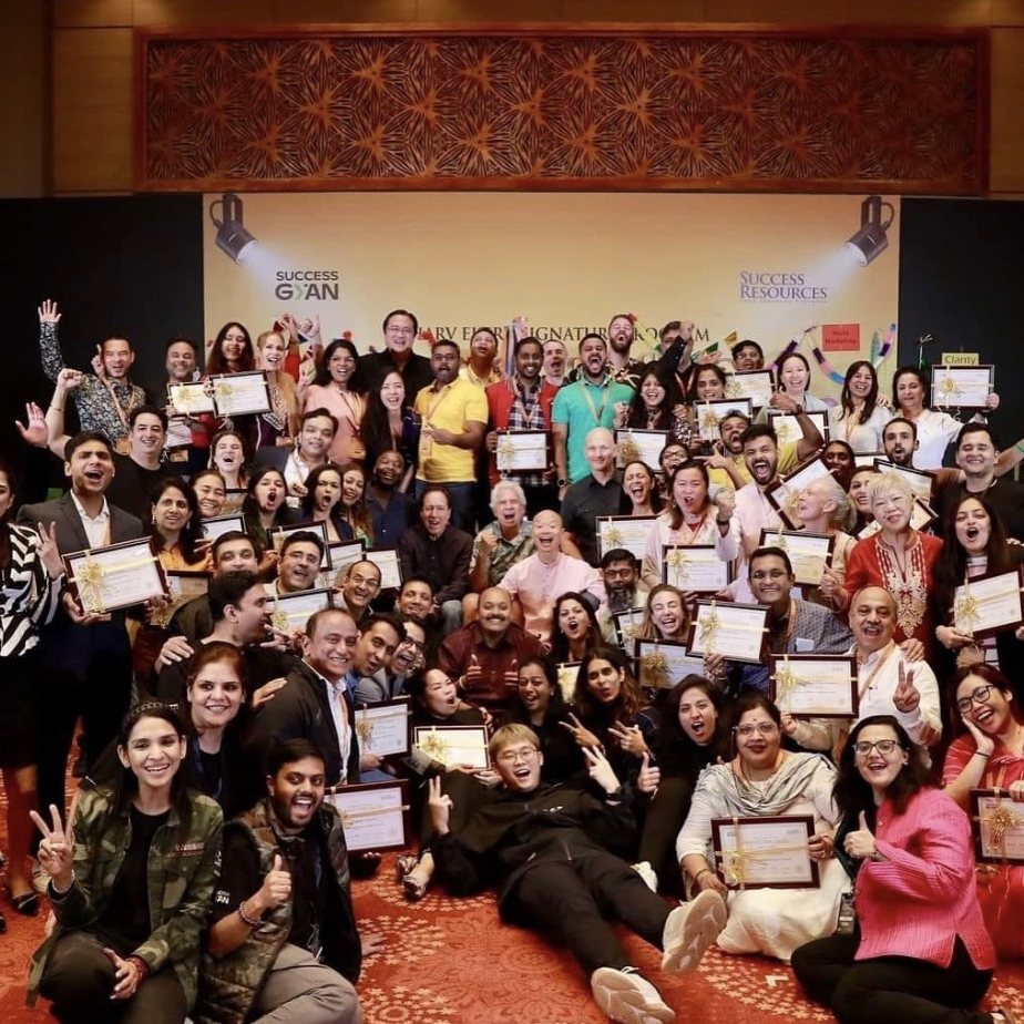 Large group of program graduates holding certificates